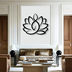 a living room filled with furniture and a large metal flower wall art on the wall