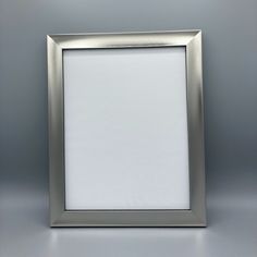 an empty silver frame on a gray background