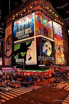 the times square in new york city is lit up at night with many billboards