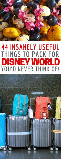 four suitcases are lined up in front of a wall with the words disney world written on them