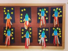 an art project with paper rockets and stars on the back of each rocket, which is attached to a bulletin board