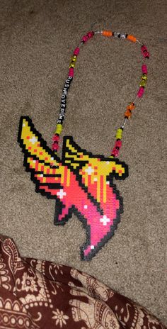 a beaded necklace with an image of a bird on it