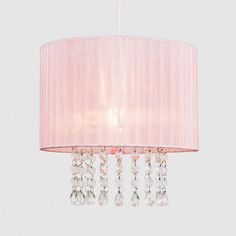 a pink chandelier hanging from the ceiling with crystal beads and a light shade