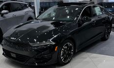 a black car is on display in a showroom