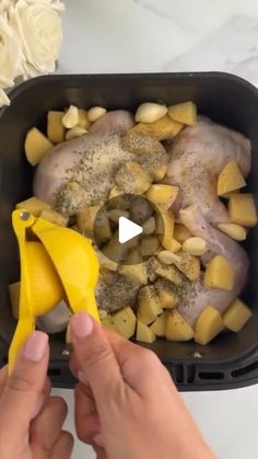 someone is peeling the peels from their chicken and potatoes in a plastic container on a marble countertop