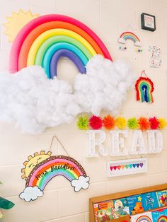 there is a rainbow and clouds on the wall