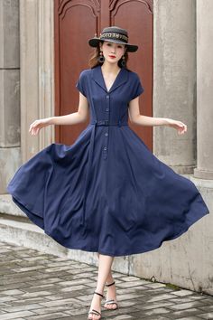 "This vintage-inspired short-sleeved shirt dress is the perfect addition to any retro lover's wardrobe! Featuring a classic collared neckline, front button closure, and a flattering A-line silhouette, this dress is both timeless and trendy. The elegant shade of blue is sure to turn heads and the lightweight fabric makes it perfect for warmer weather. DETAILS *  100% linen *  Two side pockets *  Front Button up closure *  Belted dress *  Short sleeve *  Notched collar *  Below knee Length *  Perf Short Sleeve Vintage Fashion Dresses For Spring, Spring Vintage Fashion Short Sleeve Dresses, Vintage Fashion Spring Dress With Short Sleeves, Classic Short Sleeve Dresses With Buttons, Casual Short Sleeve Dresses For Vintage Fashion, Short Sleeve Vintage Dress For Spring, Classic Short Sleeve Vintage Dress For Spring, Classic Vintage Short Sleeve Dress For Spring, Retro Short Sleeve Midi Dress For Spring