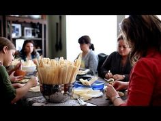 a group of people sitting around a table eating food