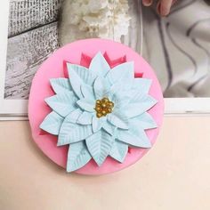 a pink box with a blue flower on top