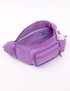 Our Fanny Sling is the cross body bag you've been waiting for! This silhouette hugs your body in all the right places and is the perfect medium size that will hold your necessities without weighing you down. Features super soft nylon webbing, piping details, color buckle, a padded exterior for extra comfort and insulation, 3 separate zipper compartments, and two additional pockets in the main compartment. Coordinating paracord pulls make opening this bag a cinch! Comes with a matching Mokuyobi M Purple Nylon Shoulder Bag For School, Functional Nylon Chest Bag, Purple Nylon Bags, Sporty Nylon Chest Bag For Travel, Nylon Crossbody Bag With Water Bottle Pocket, Sporty Nylon Chest Bag With Functional Pockets, Nylon Shoulder Bag With Functional Pockets For School, Functional Nylon Belt Bag For Commuting, Nylon Crossbody Belt Bag For Outdoor Activities