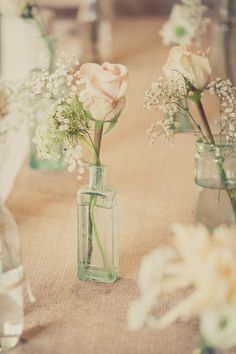 two vases filled with flowers on top of a table