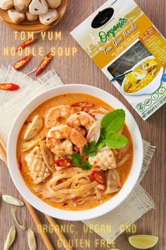 a bowl filled with noodles and shrimp next to some other food on a table top