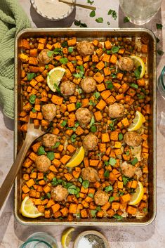 a pan filled with meatballs and sweet potatoes