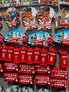 london souvenirs and magnets are displayed on a wall in the united kingdom