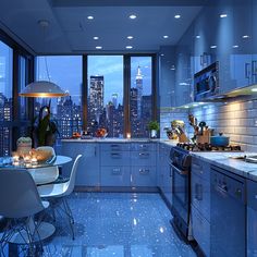 a kitchen filled with lots of counter top space next to a window covered in lights