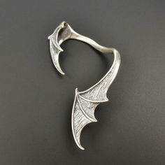 SINGLE LEFT SIDE large vampire bat wing ear climber! Fantastic design with amazing details! Handmade from solid sterling silver. The surface is slightly brushed and oxidized to create depth and texture. Gothic Winged Jewelry For Gifts, Gothic Winged Jewelry Gift, Halloween Claw-shaped Jewelry Gift, Halloween Jewelry Gift With Claw Shape, Halloween Gift Jewelry With Claw Shape, Silver Punk Style Ear Cuff Gift, Silver Punk Style Ear Cuff For Gift, Fantasy Winged Jewelry Gift, Silver Fantasy Style Ear Cuff For Gift