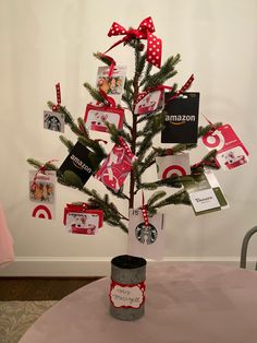 a small christmas tree decorated with pictures and cards