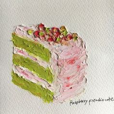 a piece of cake with pink, green and white frosting on it's side