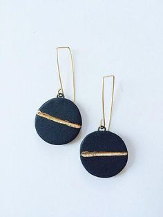 black and gold earrings on white background