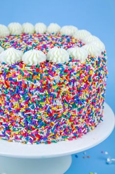 a cake with sprinkles and white frosting