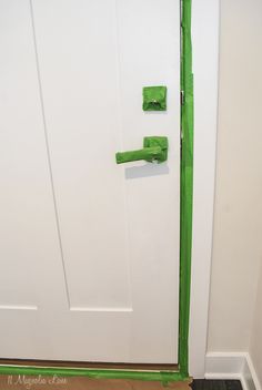 a white door with green tape on it