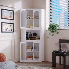 a white bookcase sitting in the corner of a room