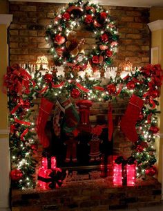 a fireplace decorated for christmas with stockings and stockings