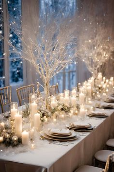 a long table with candles and plates on it