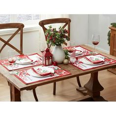 a table set with place settings for christmas dinner