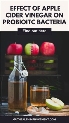 an apple cider vinegarr on a cutting board next to some apples