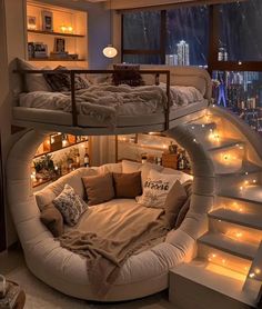 a bedroom with a spiral bed in the middle and stairs leading up to the second floor