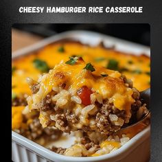 a spoon full of cheese hamburger rice casserole on top of a white dish