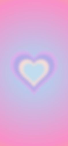 a blurry image of a heart in the middle of pink, blue and yellow