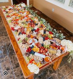 a long table covered with lots of different types of food on it's sides