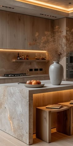 a modern kitchen with an island countertop and built in shelves on the back wall