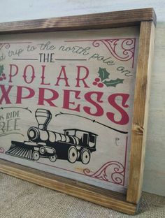 a wooden sign with the words polar express on it and a train drawn in red