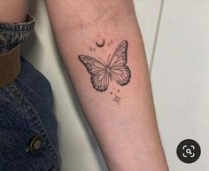 a woman's arm with a butterfly and moon tattoo on the left inner arm