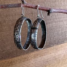 Add a touch of sophisticated Western style to your everyday look with our Prairie Hoops. These solid sterling silver hoop earrings feature a unique tooled leather texture that is both eye-catching and timeless. The medium statement size is perfect for dressing up or down, making them a versatile addition to your jewelry collection. Crafted from high-quality materials, the Prairie Hoops are built to last. The sterling silver earwire is nickel-free and hypoallergenic, so you can wear them comfortably all day long. The tooled leather texture is hand-applied, giving each pair of earrings a unique look. Whether you're dressing up for a night out or adding a touch of flair to your everyday style, the Prairie Hoops are sure to turn heads. Small Hoop Engraved Earrings, Engraved Small Hoop Jewelry, Silver Hoop Jewelry With Engraving, Etched Hoop Earrings As Gift, Silver Engraved Hoop Jewelry, Small Hoop Engraved Sterling Silver Earrings, Silver Engraved Small Hoop Earrings, Sterling Silver Engraved Hoop Earrings For Anniversary, Engraved Small Hoop Sterling Silver Earrings