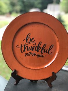 an orange plate with the words be grateful on it