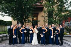 a group of people in formal wear posing for a photo