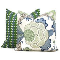 two pillows with green and blue designs on them