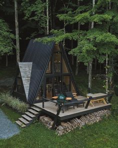 a - frame cabin in the woods surrounded by trees