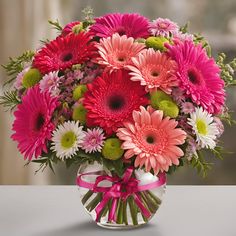 a vase filled with lots of pink and white flowers