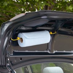 an open car trunk with toilet paper in it