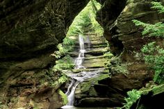 a small waterfall in the middle of some rocks