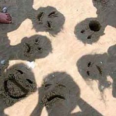 several people standing in the sand with their shadows on them