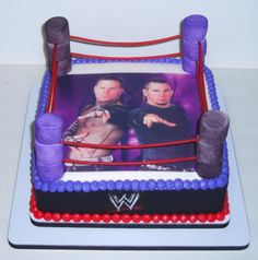 a birthday cake with two men in wrestling gear on it's sides and one man holding a bat