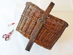 a wicker basket sitting on top of a table next to scissors