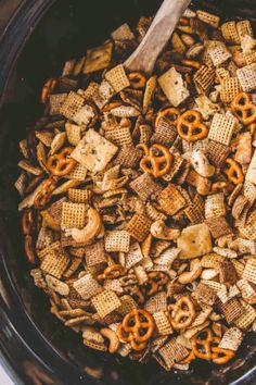 a crock pot filled with cheetos and pretzels