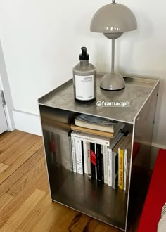 a table with a lamp and some books on it